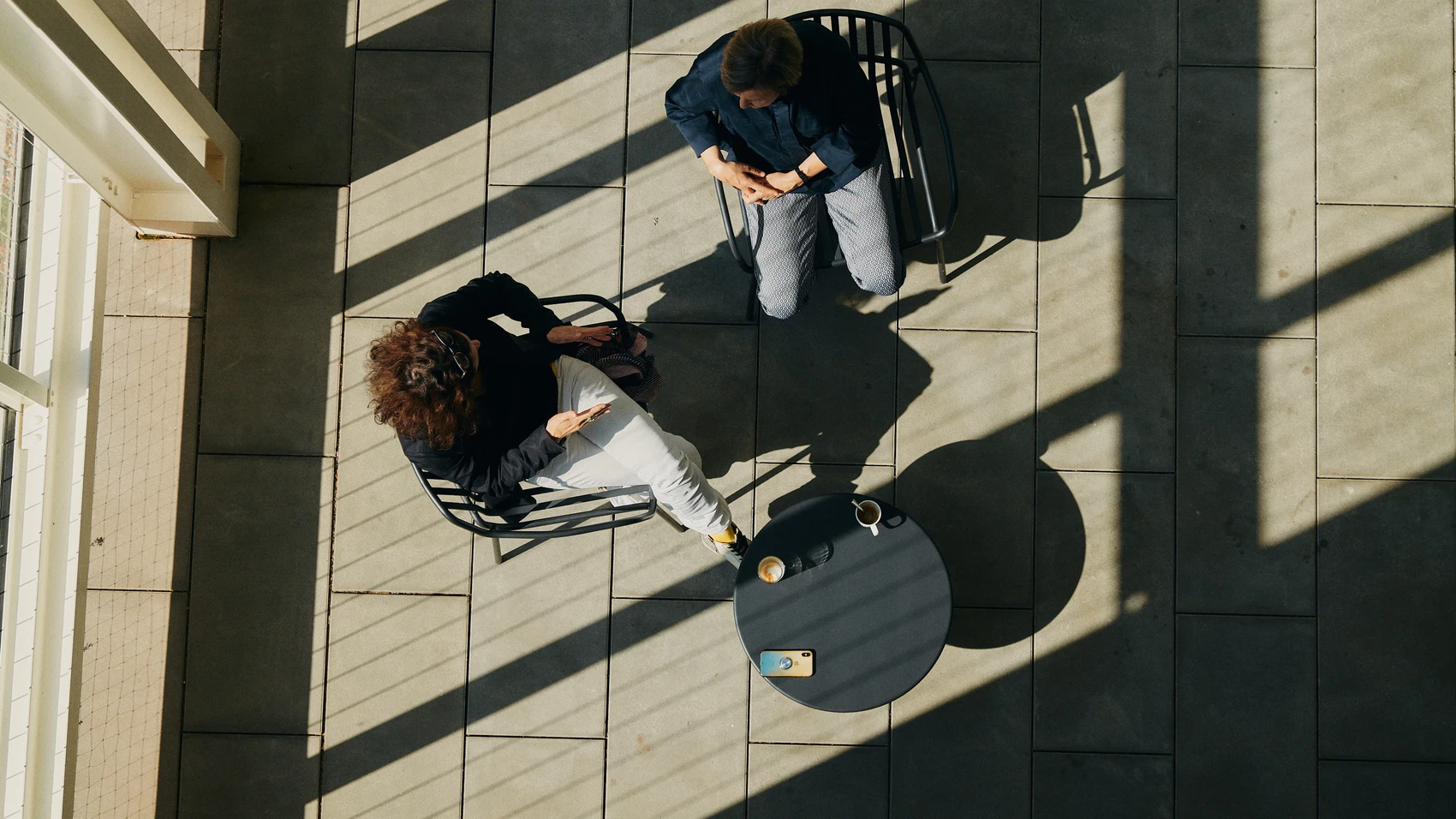 UnternehmerTUM - Munich Urban Colab - top view on two coworkers discussing a topic