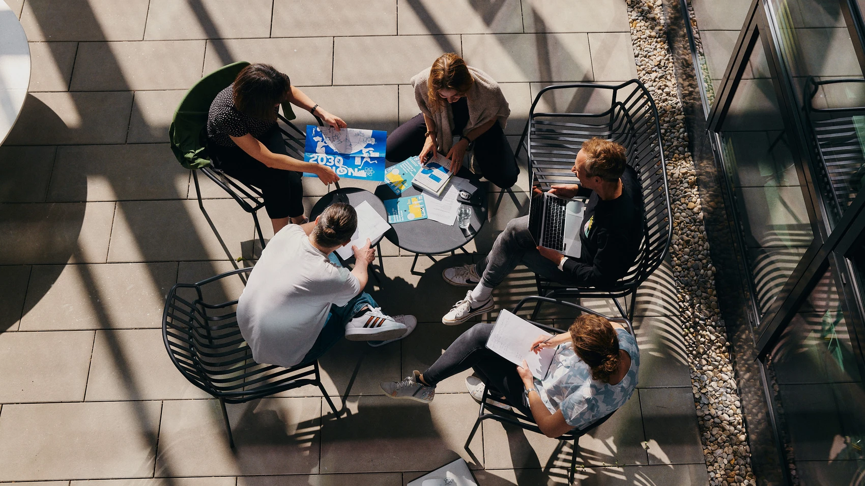 UnternehmerTUM - Munich Urban Colab - Coworkers discussing topics in open space - top view
