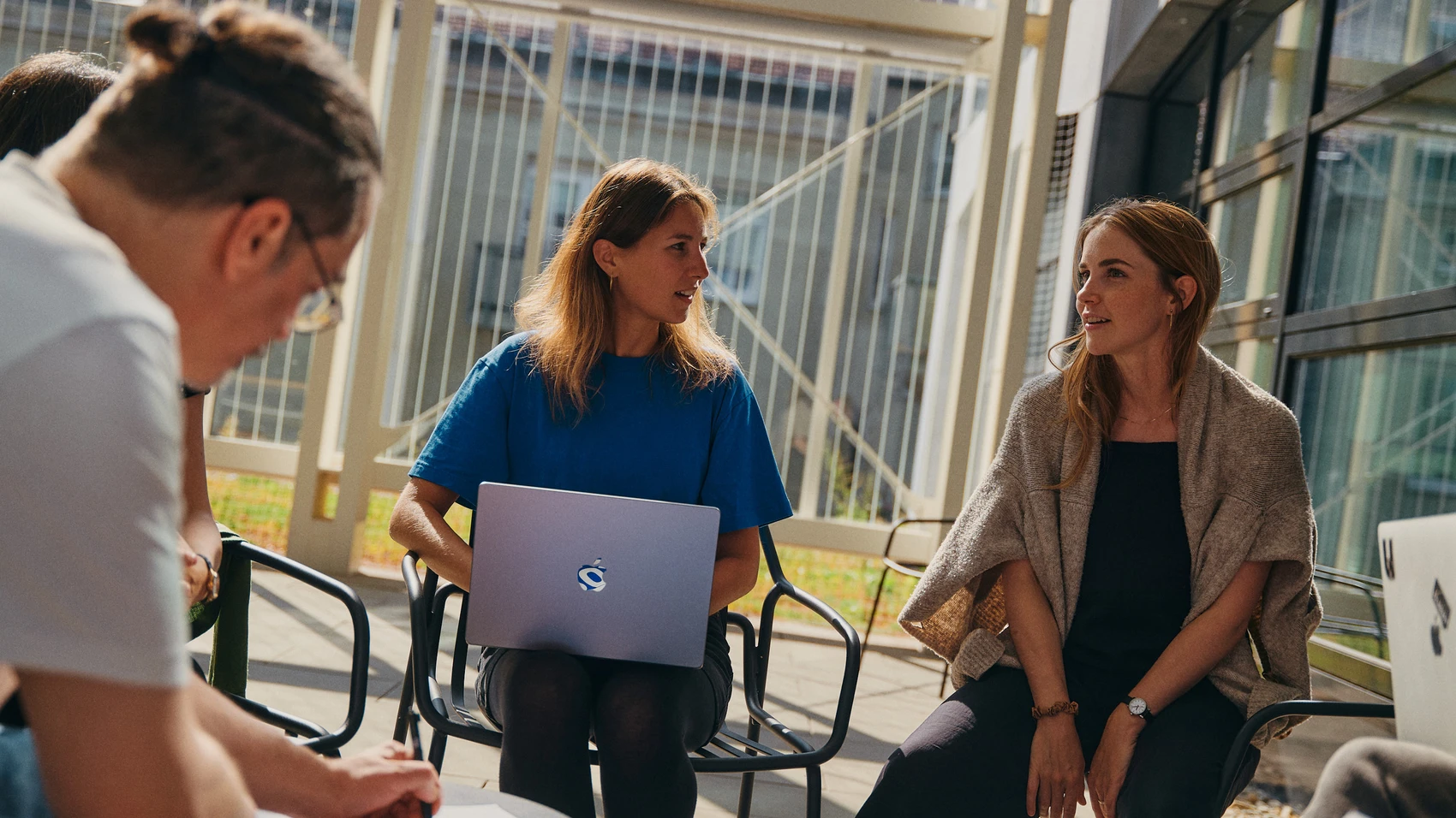 UnternehmerTUM - Munich Urban Colab - Coworkers discussing topics in open space - close up on two students