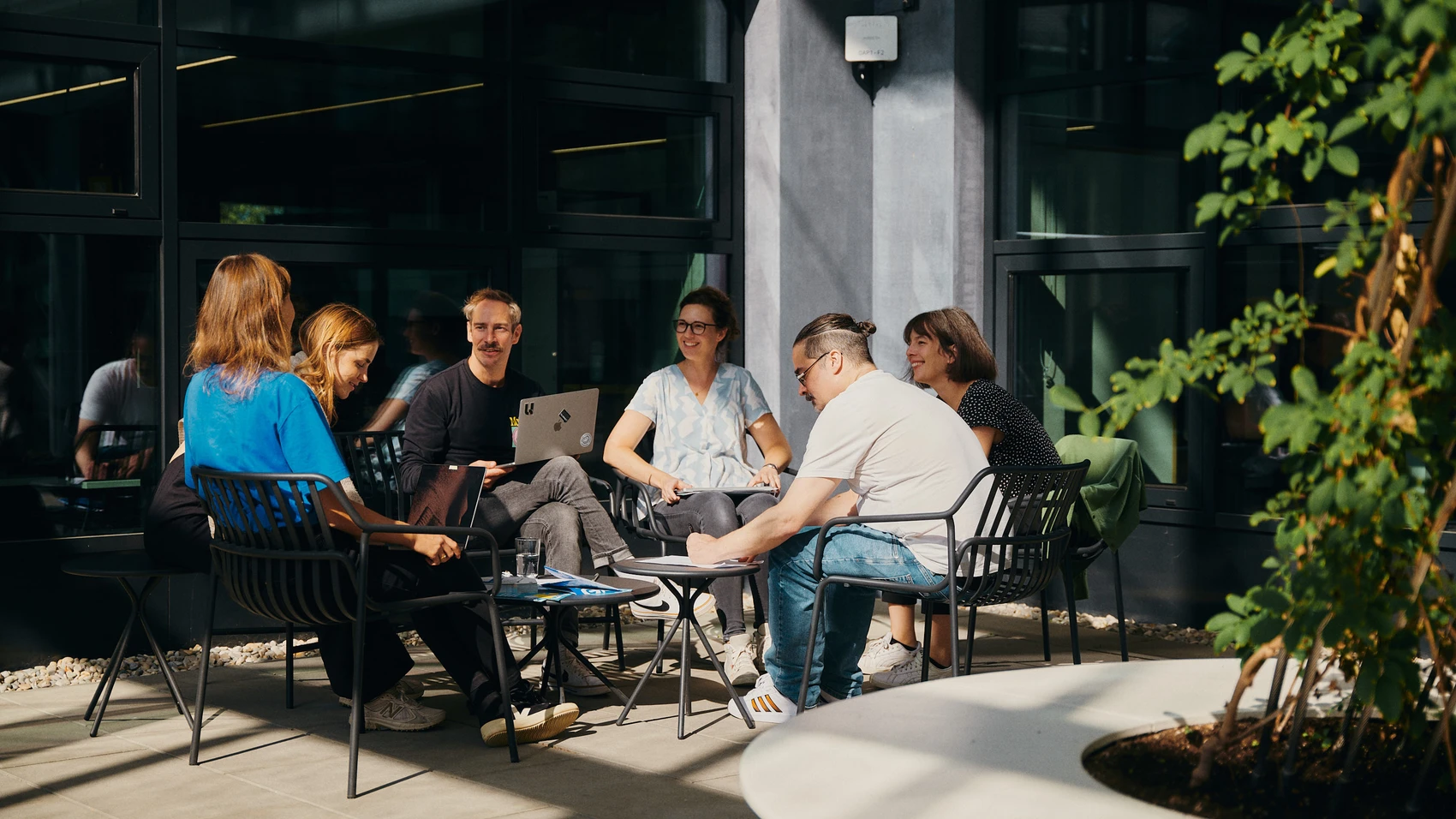 UnternehmerTUM - Munich Urban Colab - Coworkers discussing topics in open space - close up